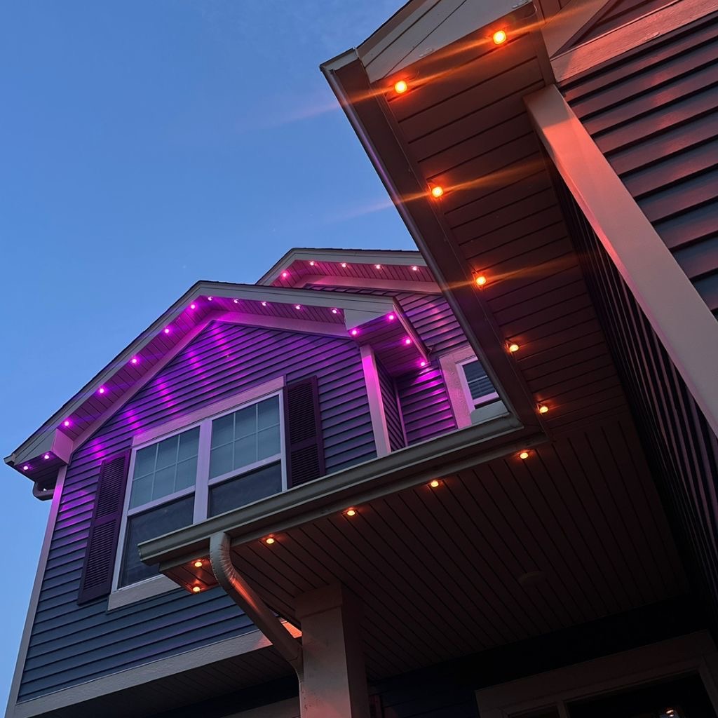 Purple accent lighting on a gable at dusk