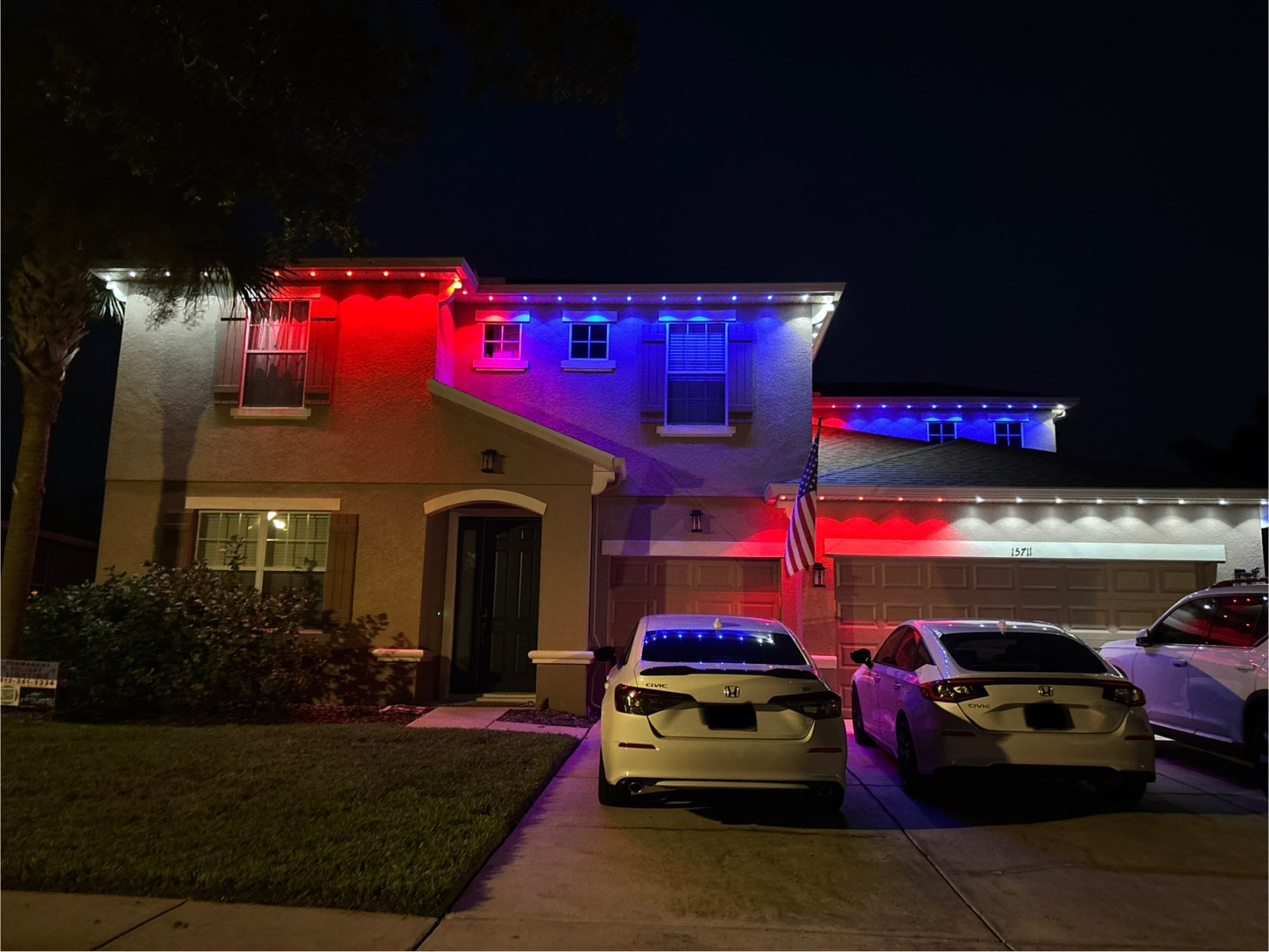 Red, white and blue accent lighting on a stucco home