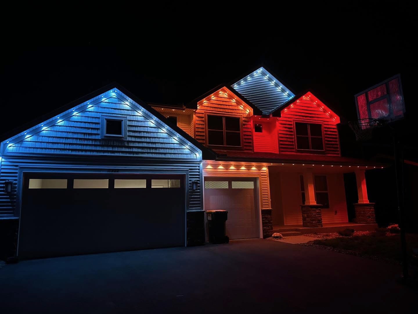 Red, white and blue game day lighting on a two-story home